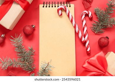 Composition with blank notebook, Christmas gifts and decorations on red background, closeup - Powered by Shutterstock