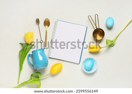 Composition with blank recipe book, Easter eggs, kitchen utensils and tulip flowers on light background