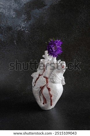 Composition with bleeding and broken heart and flower - a concept of emotional pain in relationship or breakup.