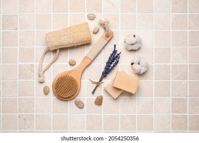 Composition With Body Brush And Bath Supplies On Light Tile Background