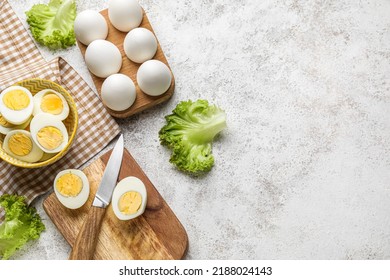 Composition with boiled chicken eggs and lettuce on light background