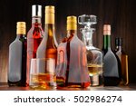 Composition with bottles of assorted alcoholic beverages.
