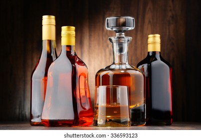 Composition with bottles of assorted alcoholic beverages and glass of whisky - Shutterstock ID 336593123