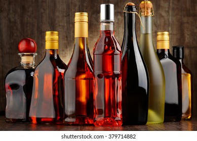 Composition with bottles of assorted alcoholic beverages.