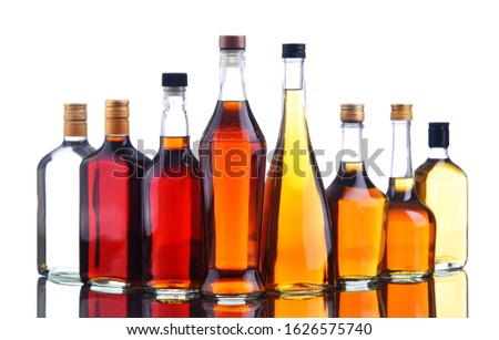 Composition with bottles of assorted alcoholic beverages.