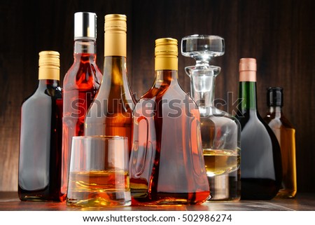 Composition with bottles of assorted alcoholic beverages.
