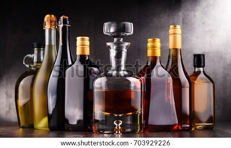 Composition with bottles of assorted alcoholic beverages.