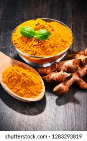 Composition with bowl of turmeric powder on wooden table. - Shutterstock ID 1283293819