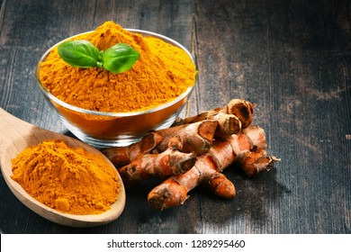 Composition with bowl of turmeric powder on wooden table. - Shutterstock ID 1289295460