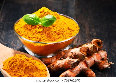 Composition with bowl of turmeric powder on wooden table. - Shutterstock ID 762961240