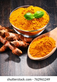 Composition with bowl of turmeric powder on wooden table. - Shutterstock ID 762961249