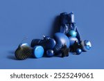 Composition with boxing gloves and beautiful Christmas decorations on blue background