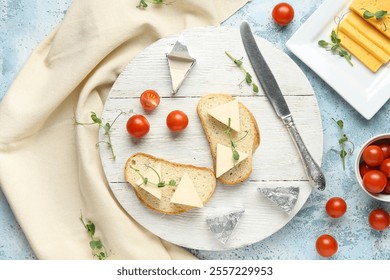 Composition with bread, triangles of tasty processed cheese, tomatoes and micro green on color grunge background
