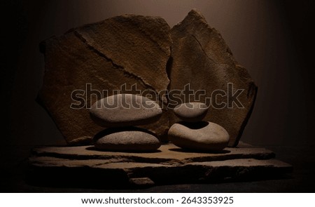 Composition with brown flat and smooth oval natural zen stones with texture for podium presentation background.minimalist composition still life for cosmetic background