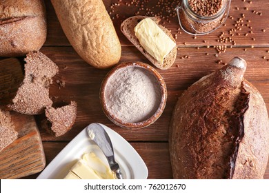 Composition with buckwheat flour and fresh bread on wooden table - Shutterstock ID 762012670