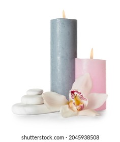 Composition with burning candles, spa stones and orchid flower on white background