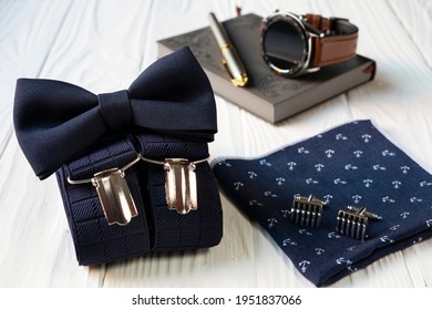 Composition of business accessories for men in vintage style - bow tie, suspenders, handkerchief and cufflinks.