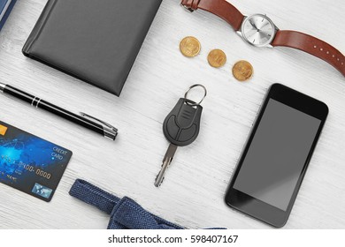 Composition of businessman accessories on white wooden table