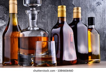 Composition with carafe and bottles of assorted alcoholic beverages. - Shutterstock ID 1084606460
