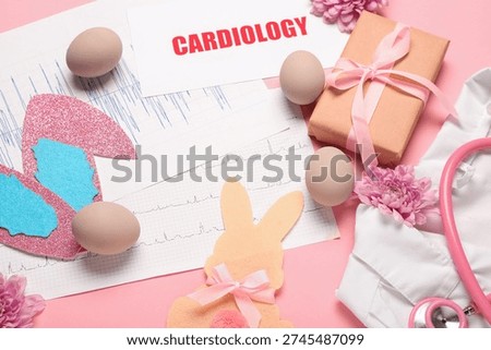 Composition with cardiograms, gift box and Easter decor on pink background