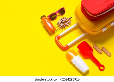 Composition Of Child Beach Accessories With First Aid Kit On Color Background. Travel Concept