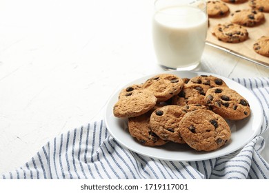 Composition With Chip Cookies And Milk On White Table