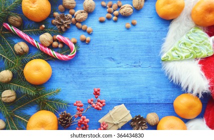Composition for Christmas and New year - oranges, walnuts, hazelnuts, candies, meringue, cookies, cranberry, clove, cinnamon and star anise. Spices, sweets and nuts. Christmas background  - Shutterstock ID 364434830