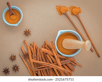 Composition of cinnamon stick and cinnamon powder in white mortar with star anise ,bay leaves and wooden spoon on brown background . - Powered by Shutterstock