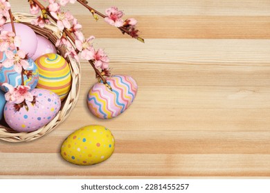 Composition with colored Easter eggs on wood background