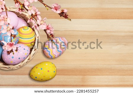 Composition with colored Easter eggs on wood background