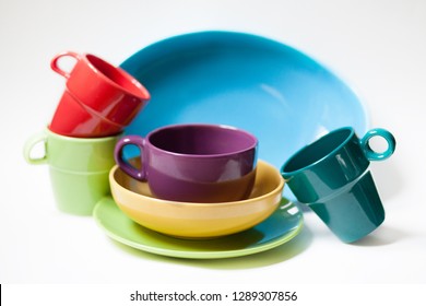 Composition With Colorful Kitchen Stuff: Mugs, Bowls, Plates. Variety Of Forms And Bright Colours. White Background