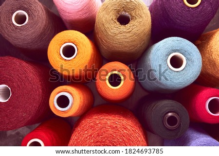 Similar – Image, Stock Photo Vibrant orange yarn spools in industrial setting