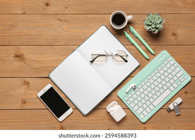 Composition with computer keyboard, cup of coffee and notebook on wooden background