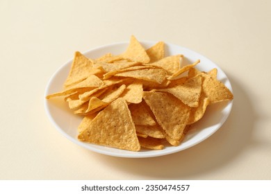 Composition with corn chips in a plate on a colored background