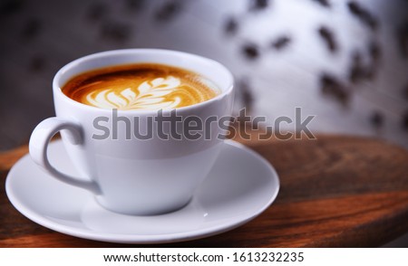 Composition with cup of caffe latte.
