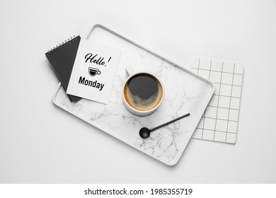 Composition with cup of coffee and greeting card with text HELLO MONDAY on white background - Powered by Shutterstock