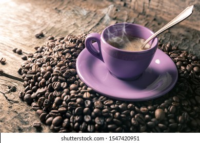 composition with a cup of coffee and roasted beans
