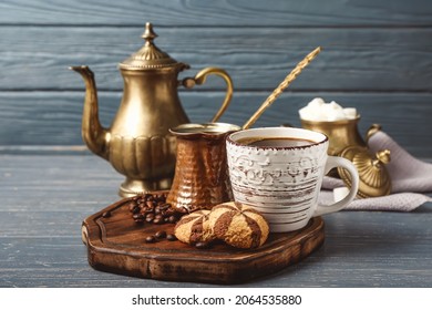 Composition with cup of hot coffee on dark wooden background