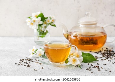 Composition with cup of jasmine tea and flowers on light background - Shutterstock ID 2041665968