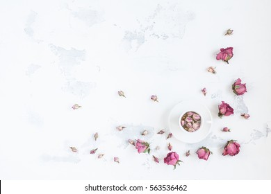 Composition With Cup Of Tea And Dried Rose Flowers. Flat Lay, Top View