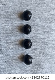 composition of dark buttons on a light gray background