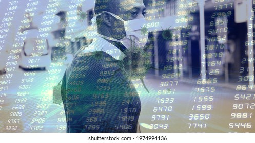 Composition of data processing and covid 19 cell over man wearing face mask in city. global covid 19 pandemic and healthcare concept digitally generated image.