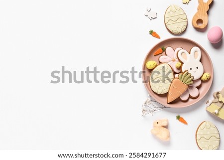Composition with decor and different Easter cookies on plate isolated on white background