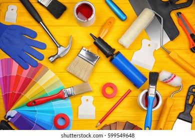 Composition Of Decorator And House Renovation Tools On Wooden Table
