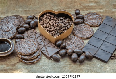 Composition of different Dark chocolate bars and pieces, Melted chocolate and Coffee beans on Old wooden background. Top view, Space for text, Selective Focus. - Powered by Shutterstock