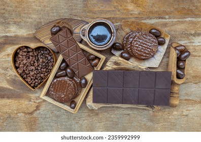 Composition of different Dark chocolate bars and pieces, Melted chocolate and Coffee beans on Old wooden background. Space for text, Selective Focus. - Powered by Shutterstock