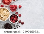 Composition with different freeze-dried fruits on light background