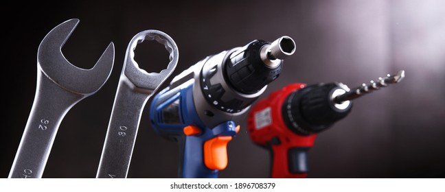Composition with different kinds of hardware tools including cordless drill, screw gun and open end spanner