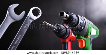 Composition with different kinds of hardware tools including cordless drill, screw gun and open end spanner