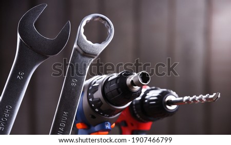 Composition with different kinds of hardware tools including cordless drill, screw gun and open end spanner